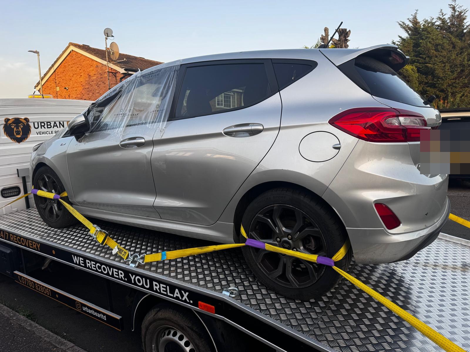 A silver hatchback loaded and strapped on the Urban Bear Recovery flatbed